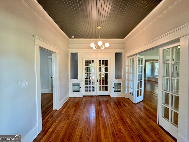 interior space with ornamental molding, french doors, a healthy amount of sunlight, and dark hardwood / wood-style flooring