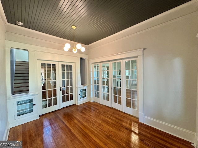 interior space featuring french doors, wood ceiling, a chandelier, and hardwood / wood-style floors