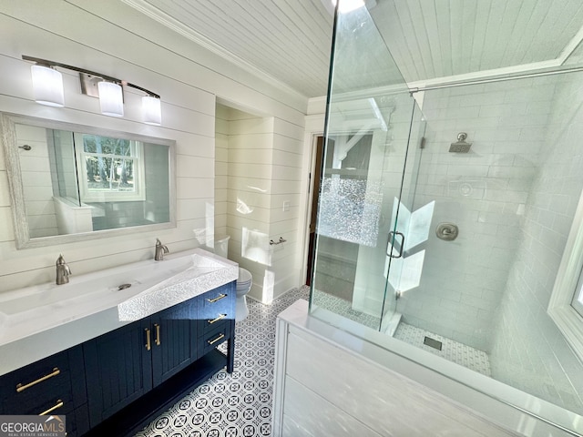 bathroom featuring wood walls, vanity, ornamental molding, and an enclosed shower