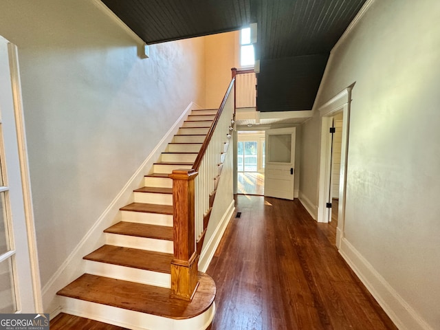 staircase with a healthy amount of sunlight and wood-type flooring