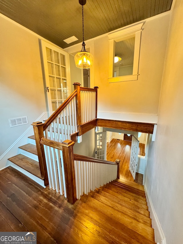 staircase with hardwood / wood-style floors