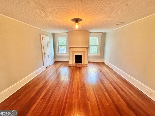 unfurnished living room featuring wood-type flooring and wooden ceiling