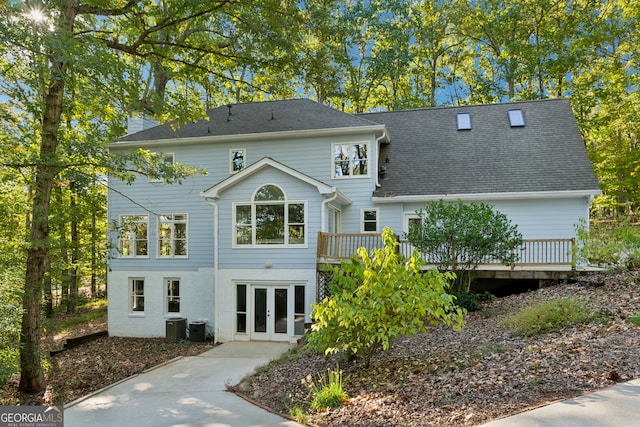 rear view of house with french doors, a deck, and central AC unit