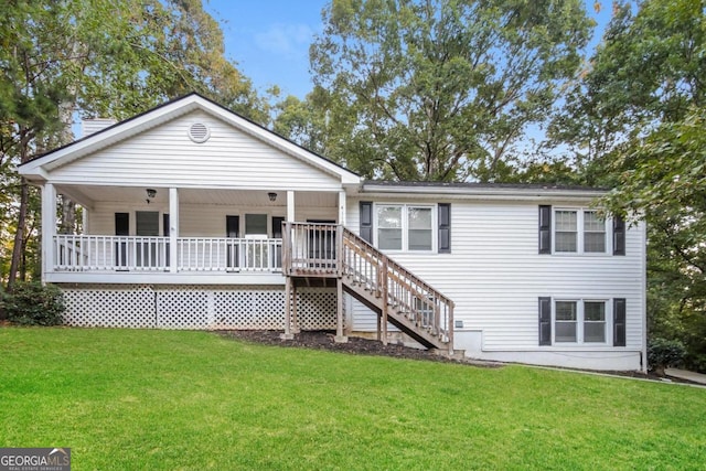 rear view of house featuring a lawn