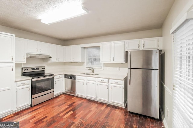 kitchen with a textured ceiling, white cabinetry, dark hardwood / wood-style floors, sink, and stainless steel appliances