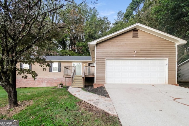 ranch-style house featuring a garage, driveway, a front yard, and a deck