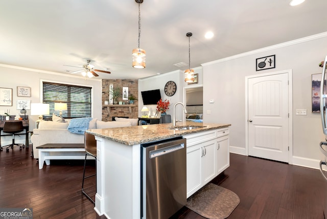 kitchen with pendant lighting, dishwasher, sink, an island with sink, and white cabinetry