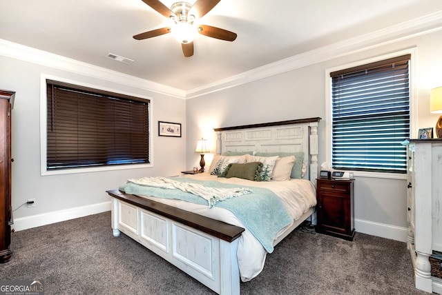 bedroom with ceiling fan, dark carpet, and ornamental molding