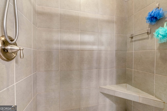 bathroom with tiled shower