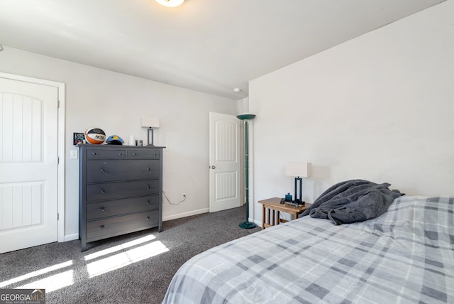 bedroom with dark colored carpet