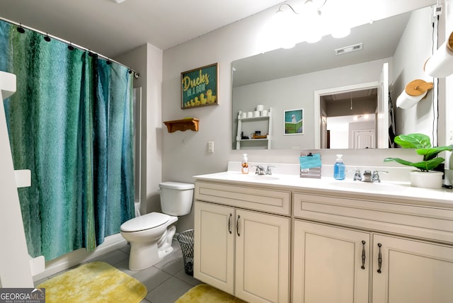 full bathroom featuring tile patterned floors, vanity, shower / bath combination with curtain, and toilet