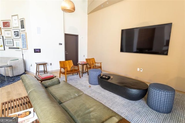 1080 Peachtree St NE Unit 1408, Atlanta, GA 30309 - living area with a towering ceiling, wood finished floors, and baseboards