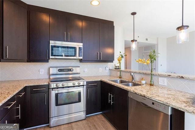 1080 Peachtree St NE Unit 1408, Atlanta, GA 30309 - kitchen with stainless steel appliances, a sink, decorative backsplash, and light stone countertops