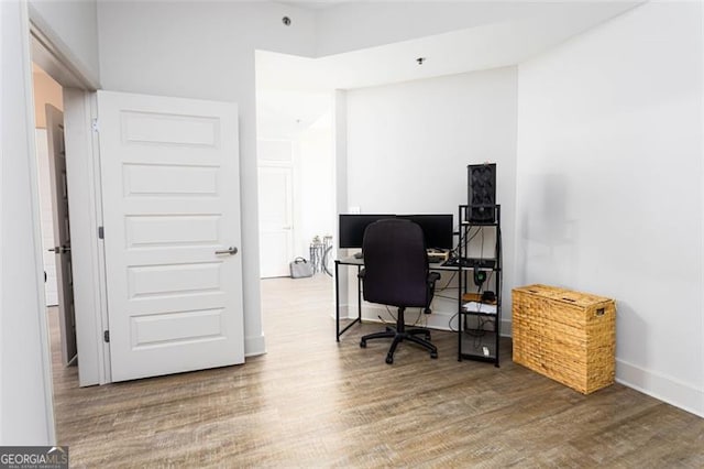 home office with hardwood / wood-style floors