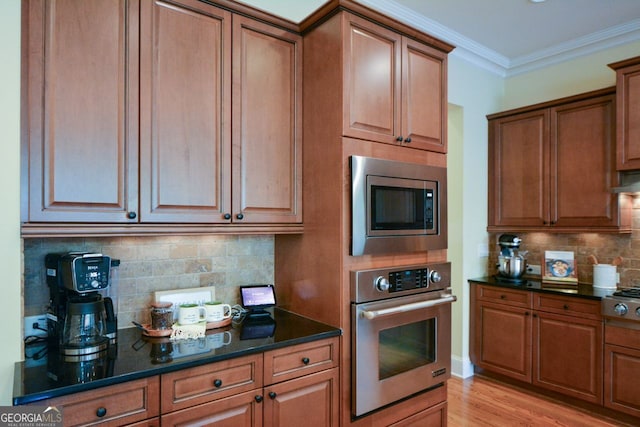 kitchen with light hardwood / wood-style flooring, decorative backsplash, stainless steel appliances, and crown molding