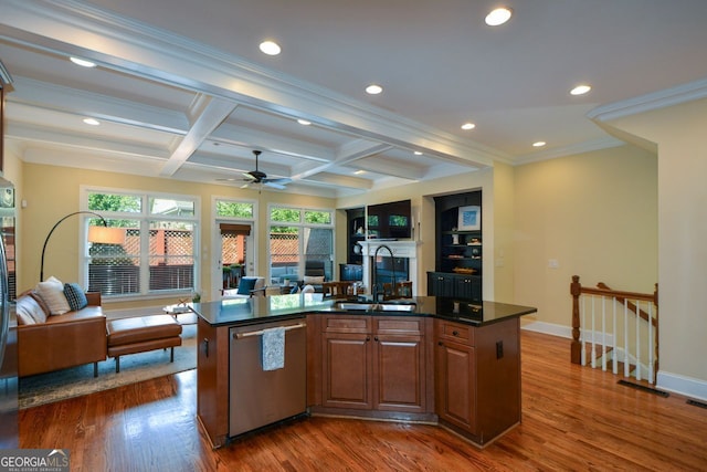 kitchen with stainless steel dishwasher, a center island with sink, sink, and dark hardwood / wood-style flooring