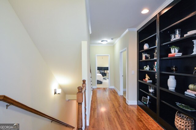 hall featuring crown molding and hardwood / wood-style flooring