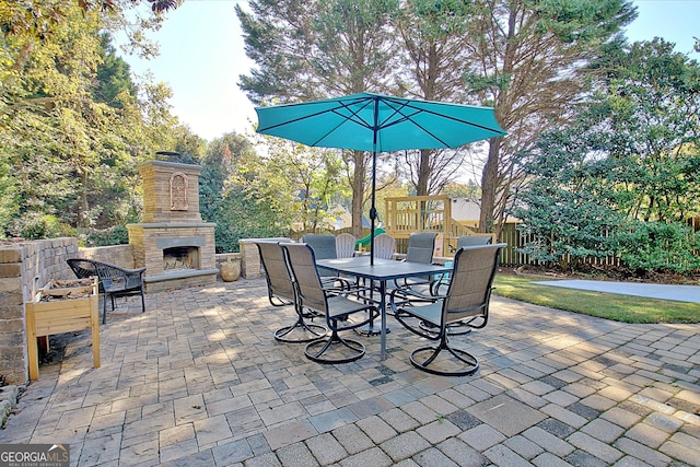 view of patio featuring an outdoor stone fireplace