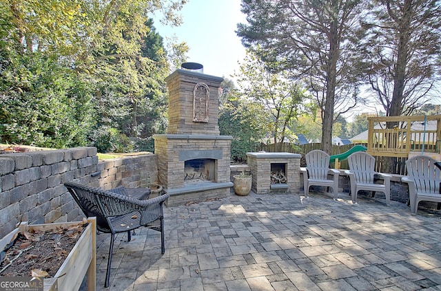 view of patio / terrace featuring an outdoor stone fireplace