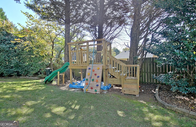 view of jungle gym featuring a lawn