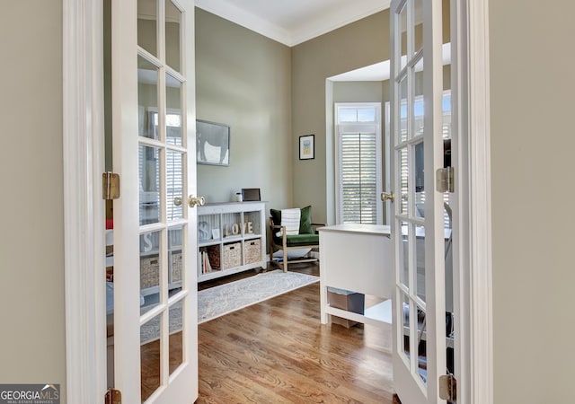 interior space with french doors, hardwood / wood-style floors, and ornamental molding