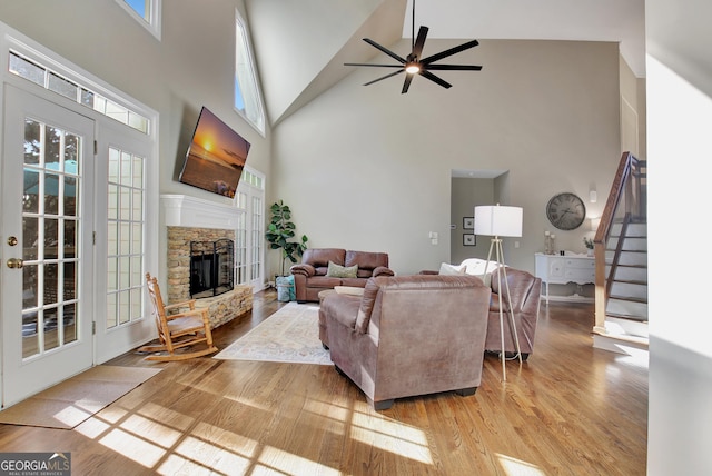 living room with ceiling fan, high vaulted ceiling, and a healthy amount of sunlight