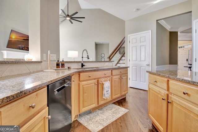 kitchen featuring dishwasher, sink, ceiling fan, light brown cabinetry, and light stone counters