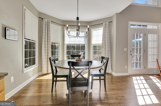 dining space featuring hardwood / wood-style floors and a notable chandelier