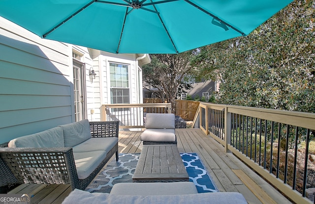 wooden deck with an outdoor living space