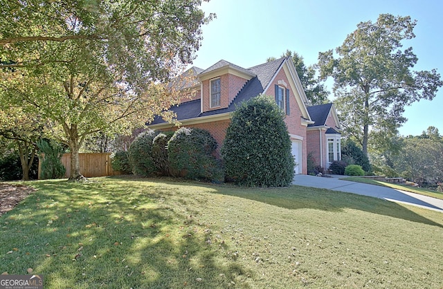 view of side of property featuring a lawn and a garage