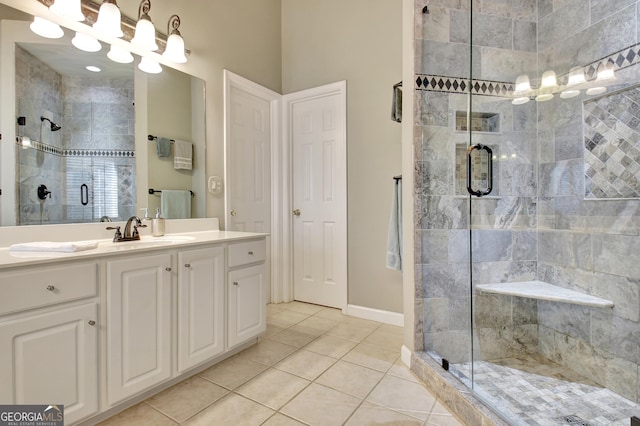 bathroom with tile patterned floors, vanity, and an enclosed shower