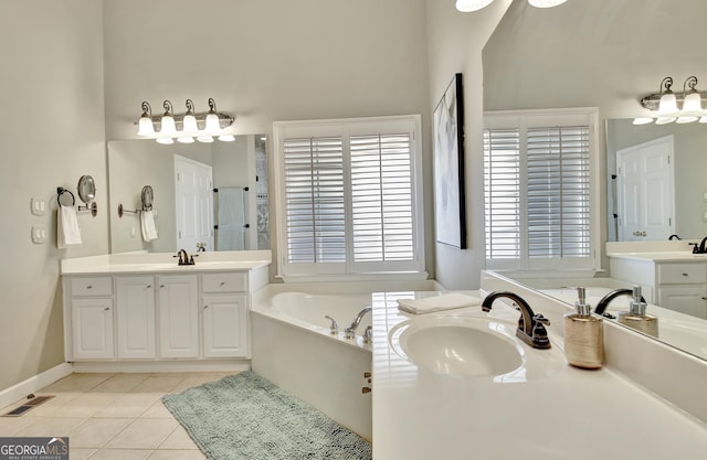 bathroom with tile patterned floors, vanity, and a bath