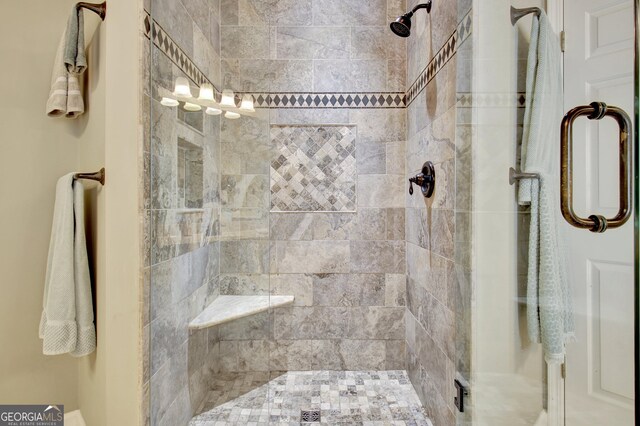 bathroom with a shower with shower door