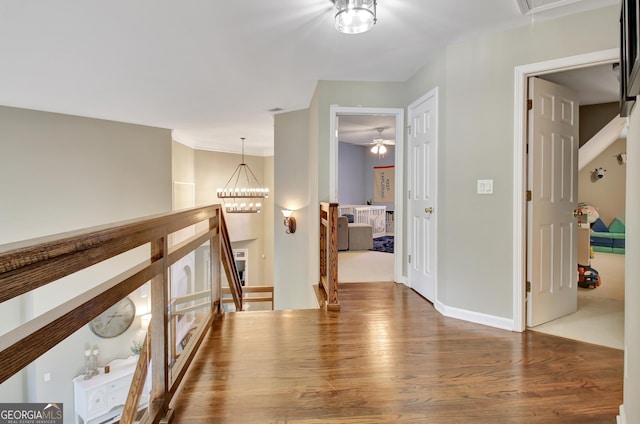 hall with a chandelier and hardwood / wood-style flooring