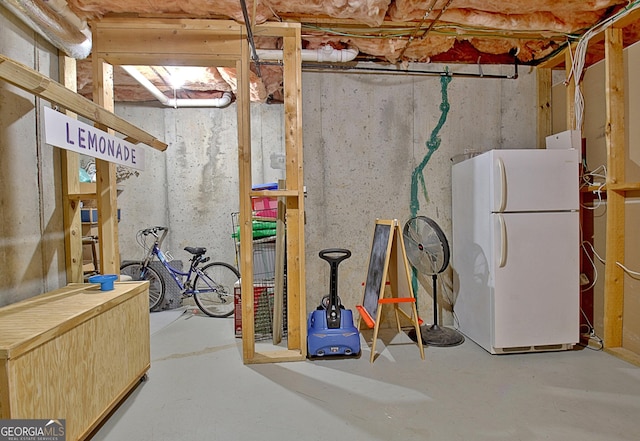 basement featuring white refrigerator