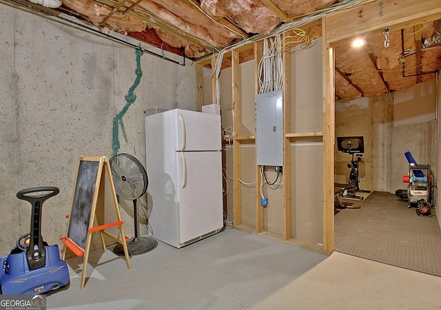 basement featuring white fridge and electric panel