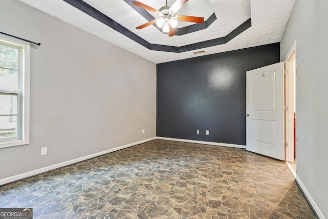 spare room featuring a textured ceiling and ceiling fan