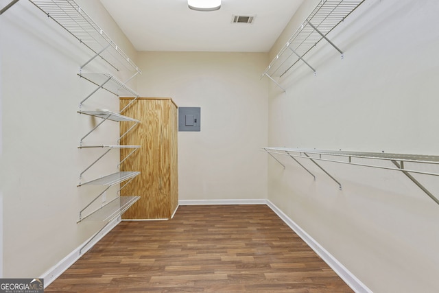 spacious closet with dark wood-type flooring