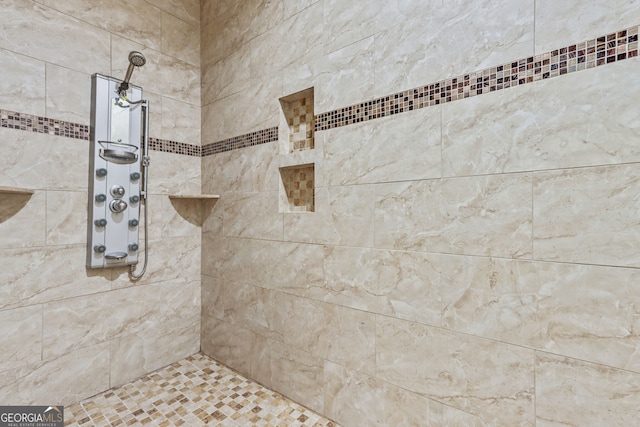 bathroom with a tile shower