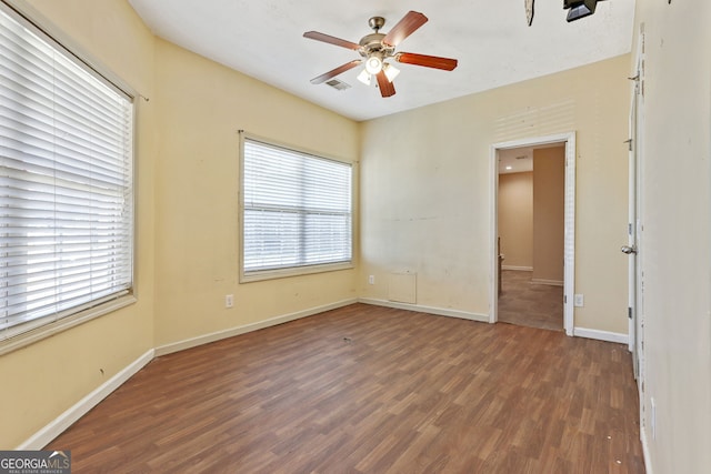 spare room with ceiling fan and dark wood-type flooring