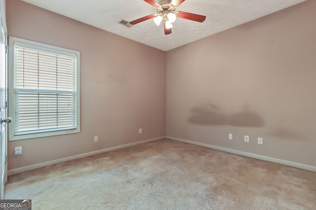 carpeted empty room featuring ceiling fan