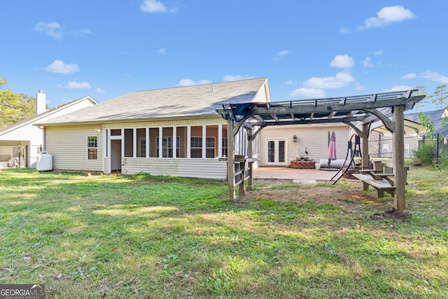 back of property featuring a patio, a lawn, a sunroom, and a pergola