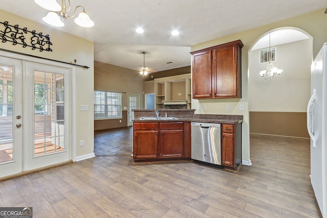 kitchen with hanging light fixtures, white fridge, an inviting chandelier, and stainless steel dishwasher