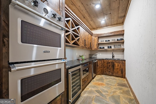 kitchen with appliances with stainless steel finishes, sink, wooden ceiling, and beverage cooler