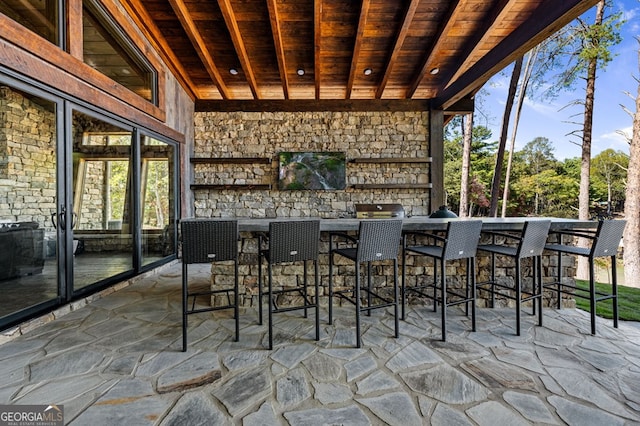 unfurnished sunroom featuring wood ceiling and lofted ceiling with beams