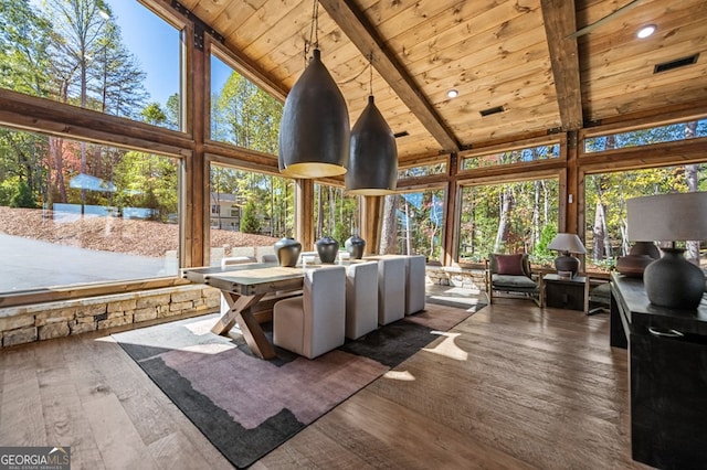 sunroom with wood ceiling, a wealth of natural light, and vaulted ceiling with beams