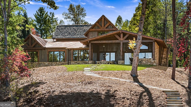 rear view of house featuring a yard