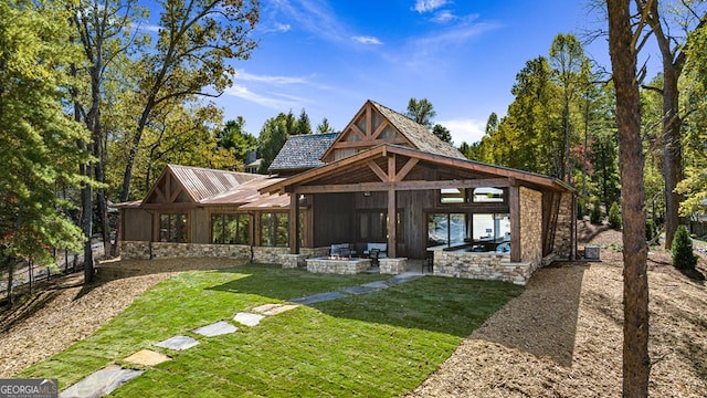 rear view of house featuring a patio area and a lawn