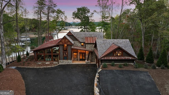 view of front of home with a water view