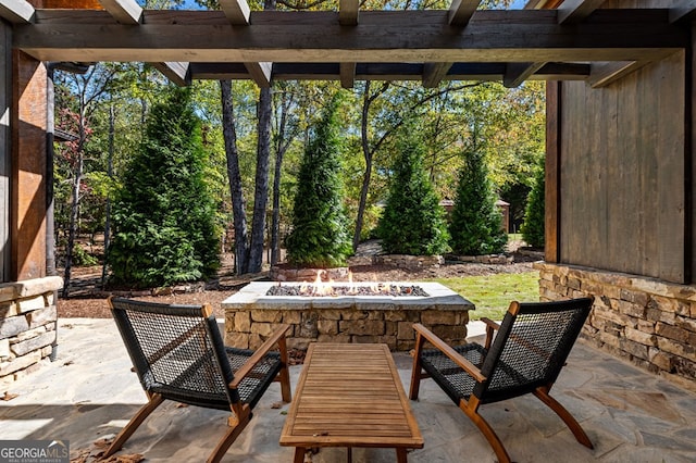 view of patio / terrace with an outdoor fire pit and a pergola